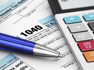 Taxes forms with a calculator and pen