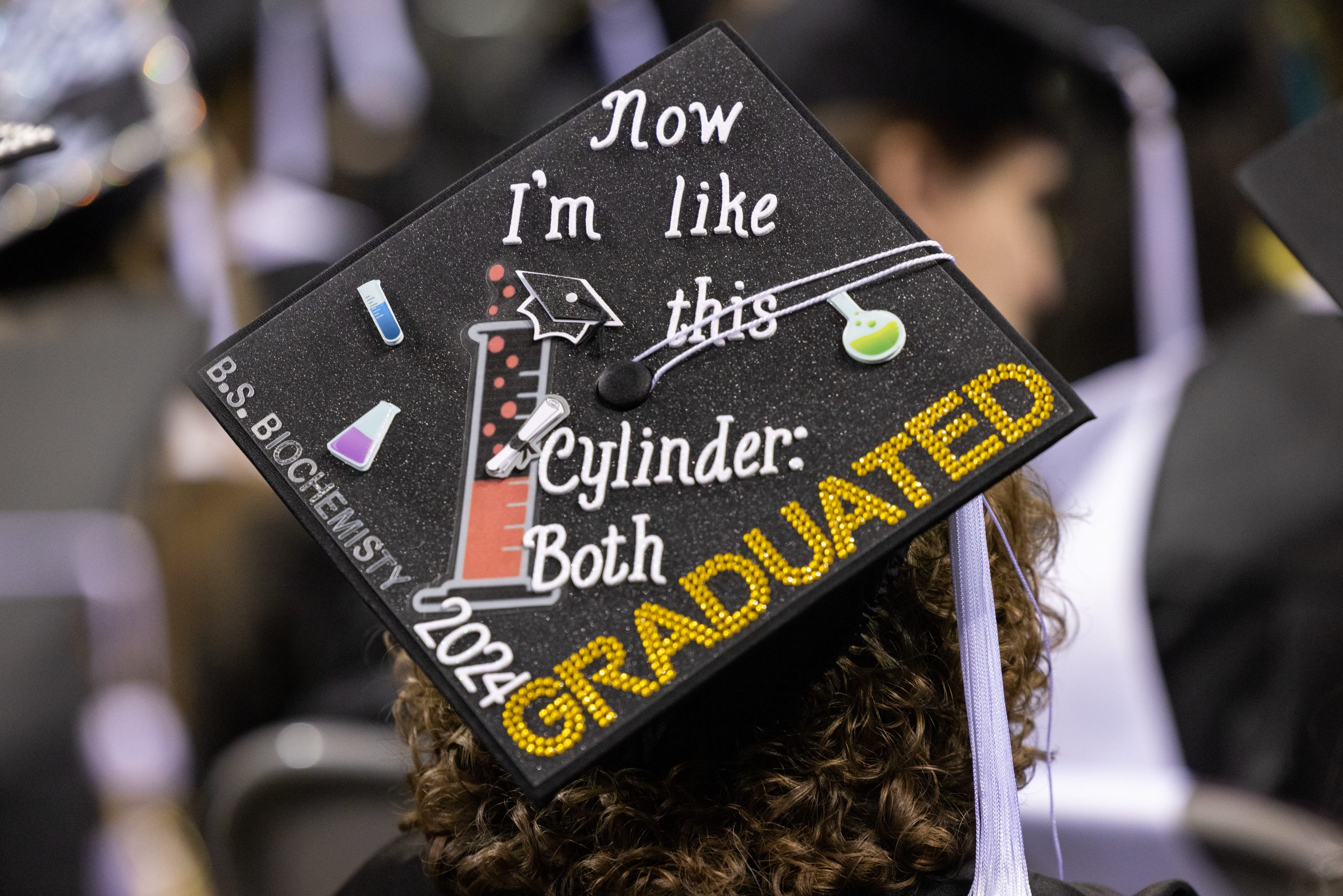 Mortarboard that reads Now I'm like this cylinder: both graduated 2024. B.S Bio Chemistry.