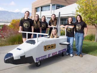 SWE Team on campus with their "coffin" cart